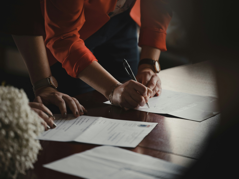 People signing legal court documents