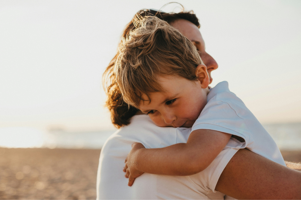 Mother hugging her son in field